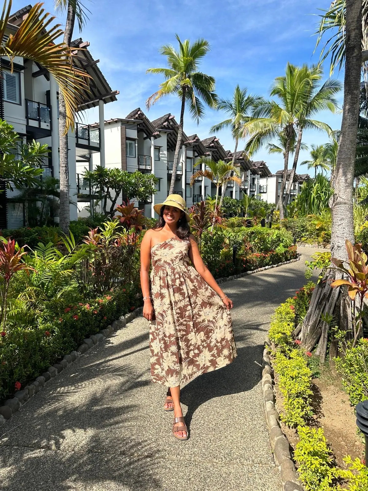 Harnoop's friend in the Cocoa One Shoulder Midi dress at tropical resort